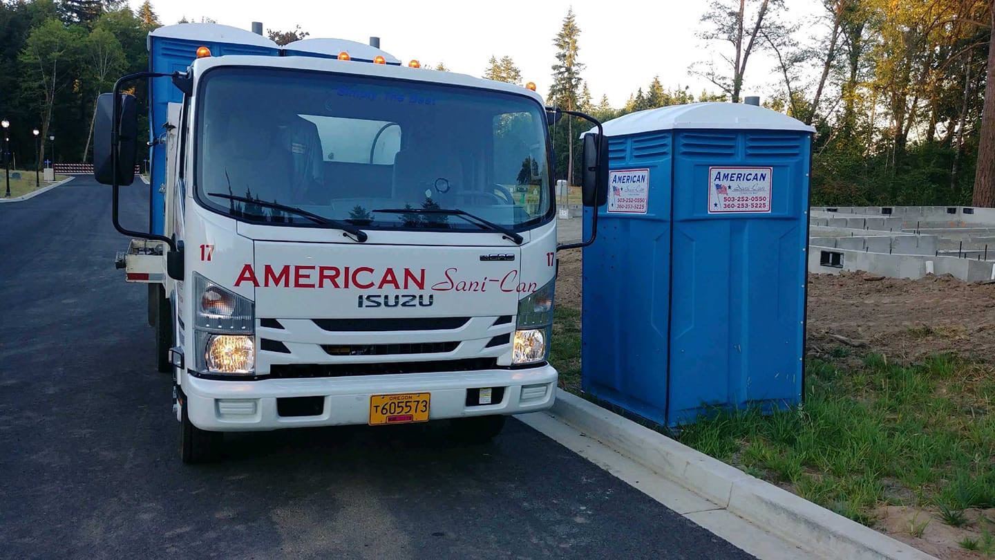 Truck servicing porta-potty