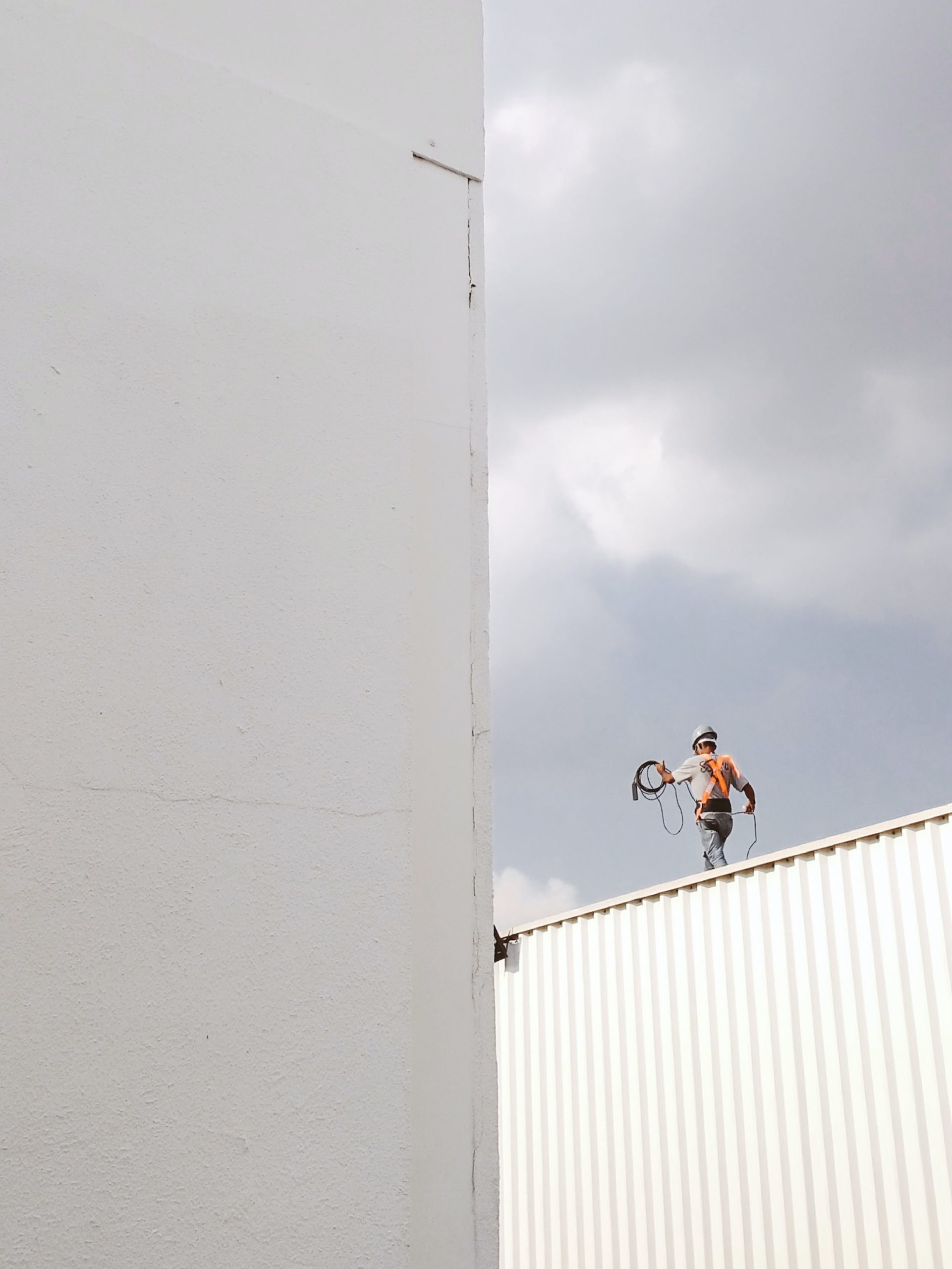 image of construction worker on top of building | portable toilet rentals for construction washington oregon