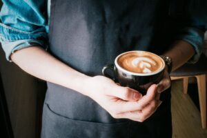 image of a barista with a cup of coffee | Porta potty portable toilet rental portland oregon salem vancouver washington