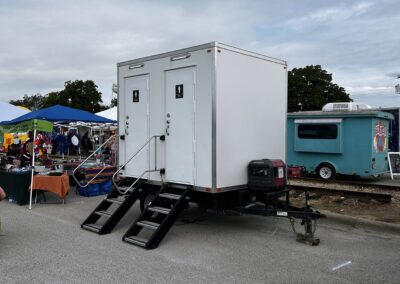 2-stall luxury restroom trailer unit at an outdoor event.