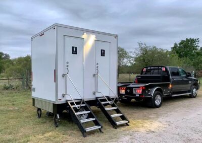 2-stall luxury restroom trailer unit at an outdoor event.