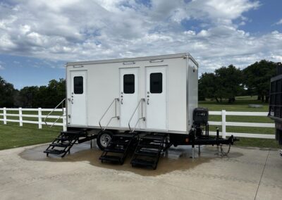 3-stall luxury restroom trailer unit at an outdoor event.