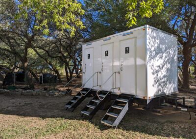 3-stall luxury restroom trailer unit at an outdoor event.